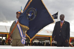 HE the President holding a community policing flag